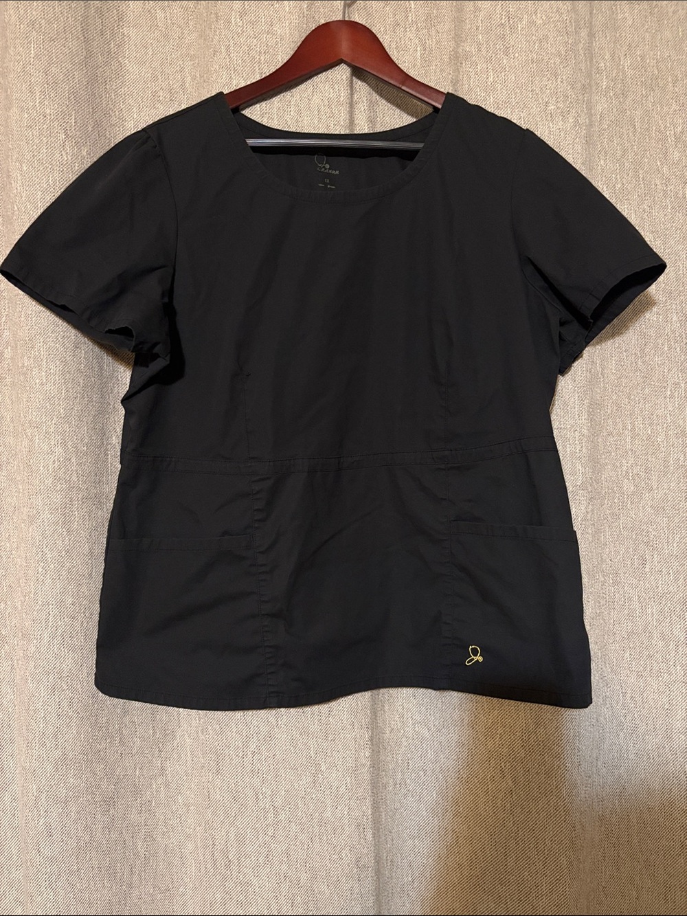 Jaanuu Black Peplum scrub Top with Front Pockets and gold zipper style J96037C
